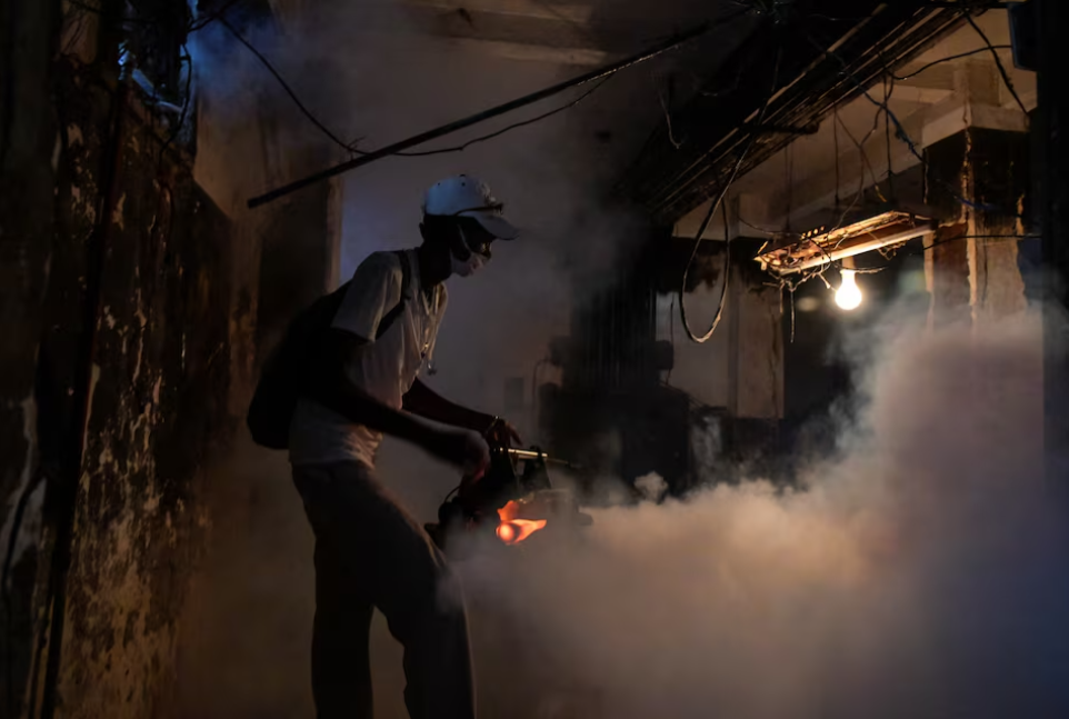 Health worker Luis Aguilar fumigates the basement of a building as Cuban health authorities launched small-scale fumigation efforts in a bid to fight the spread of the oropouche virus, in Havana, Cuba August 30, 2024. 